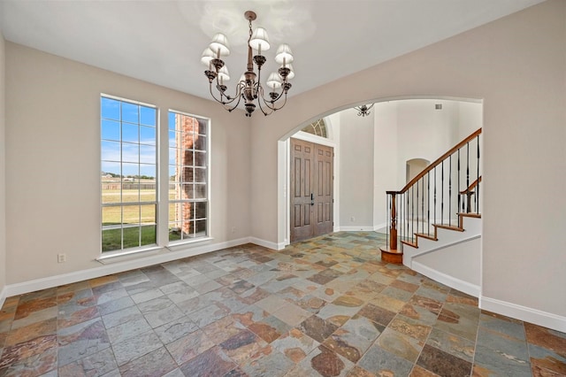 entrance foyer featuring an inviting chandelier