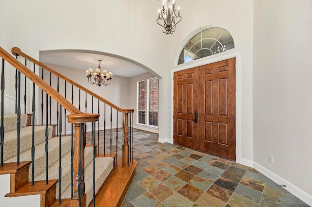 foyer entrance featuring a high ceiling and a chandelier