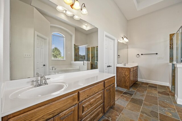 bathroom with vanity and independent shower and bath