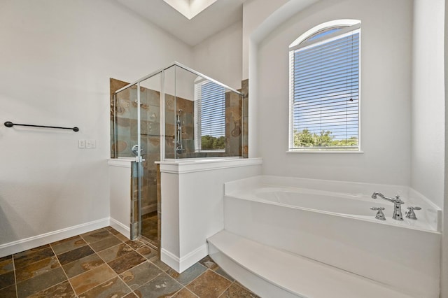 bathroom featuring independent shower and bath