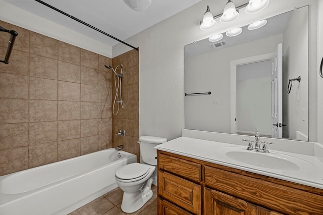 full bathroom featuring tile patterned flooring, vanity, toilet, and tiled shower / bath