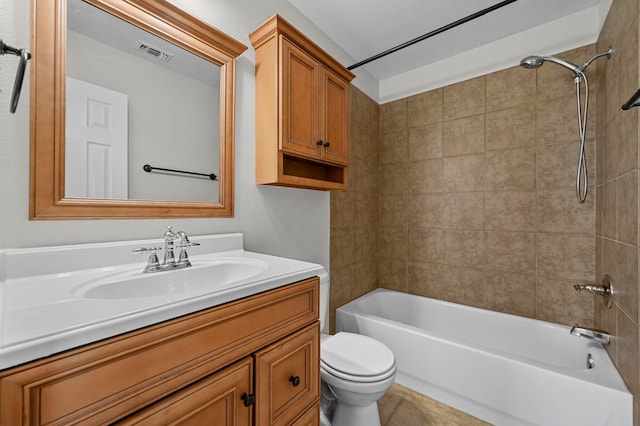 full bathroom featuring toilet, vanity, and tiled shower / bath combo