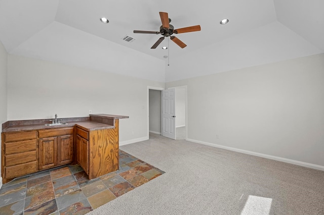 kitchen featuring dark colored carpet, a raised ceiling, sink, ceiling fan, and kitchen peninsula