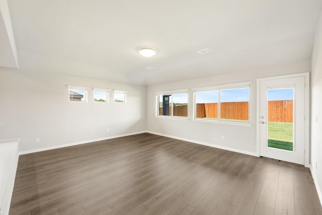 empty room with dark wood-type flooring