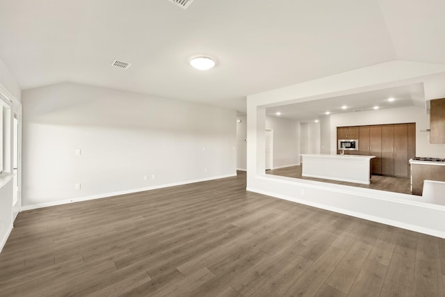 unfurnished living room featuring dark hardwood / wood-style flooring and lofted ceiling