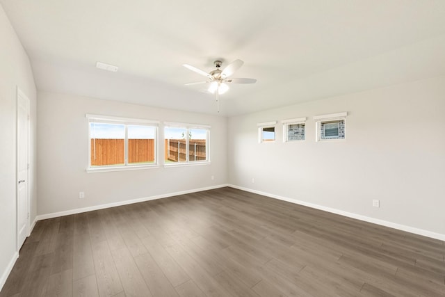 spare room with ceiling fan and dark wood-type flooring