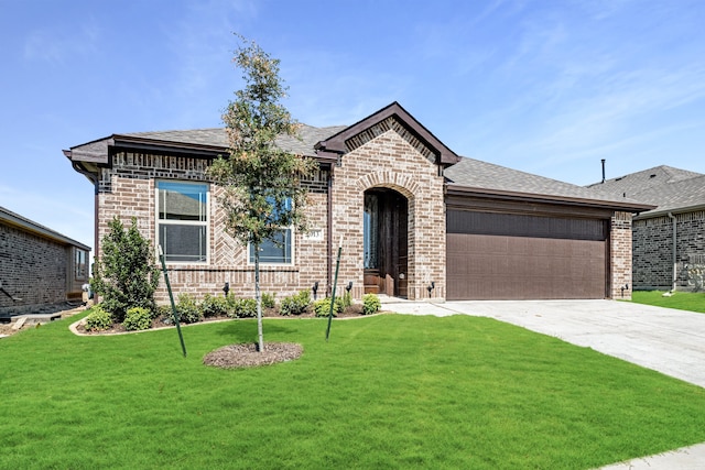 view of front of house with a garage and a front lawn