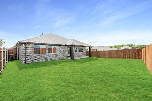 back of property with a lawn and a patio