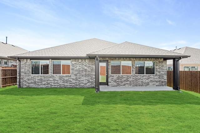 rear view of house with a yard