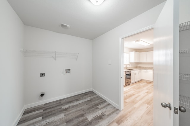 laundry room with sink, electric dryer hookup, light wood-type flooring, and washer hookup