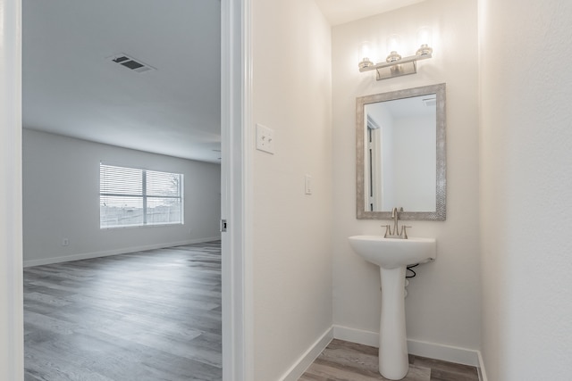 bathroom with wood-type flooring