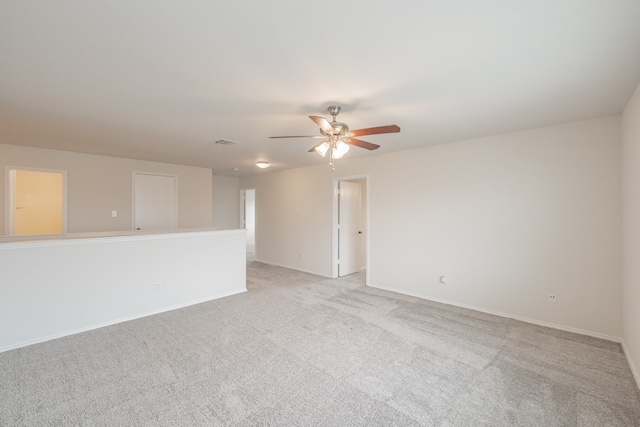 unfurnished living room featuring light carpet and ceiling fan