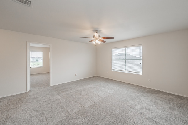 carpeted spare room with ceiling fan