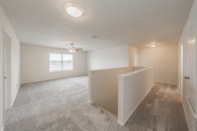 interior space featuring carpet and ceiling fan