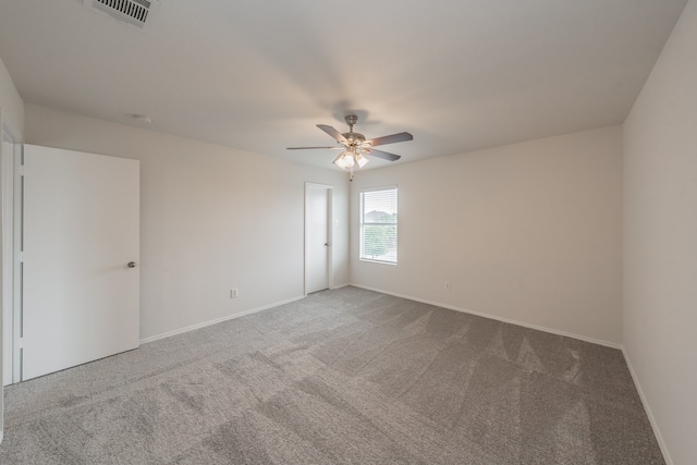 carpeted empty room featuring ceiling fan