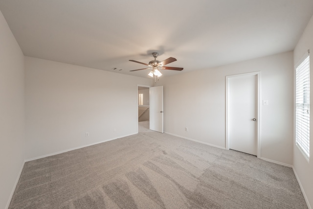 unfurnished room featuring light carpet and ceiling fan