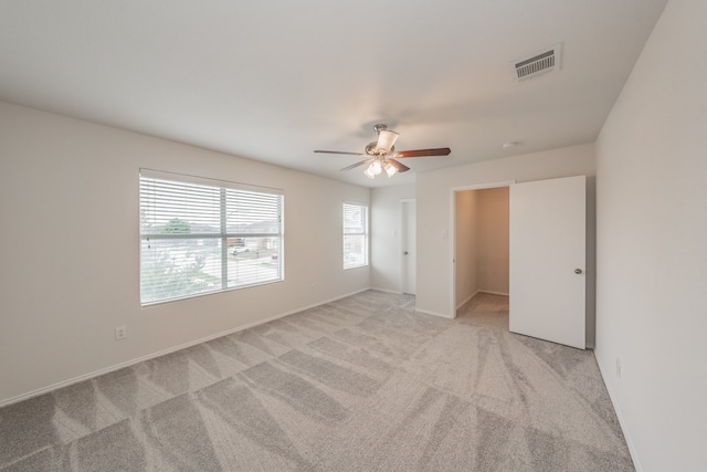 unfurnished bedroom with light colored carpet and ceiling fan