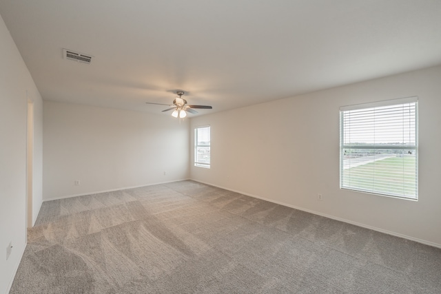 spare room featuring ceiling fan and light colored carpet