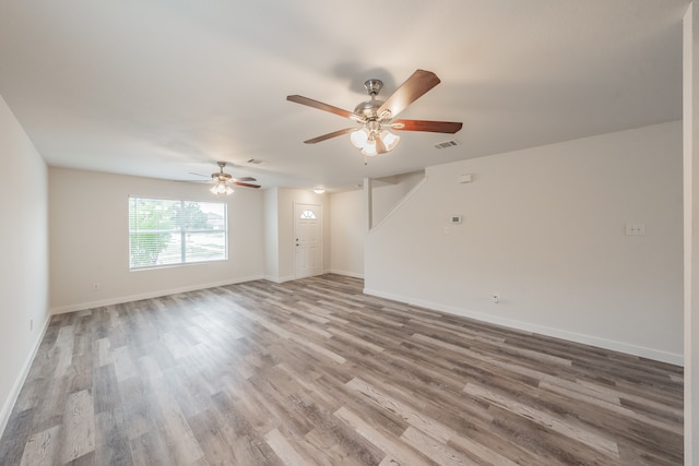 empty room with hardwood / wood-style floors and ceiling fan