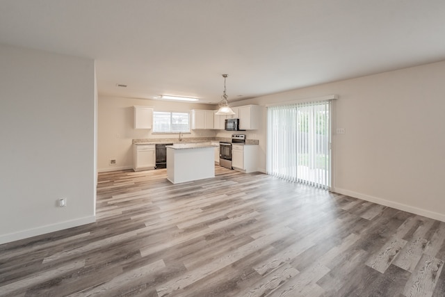 unfurnished living room with sink and light wood-type flooring