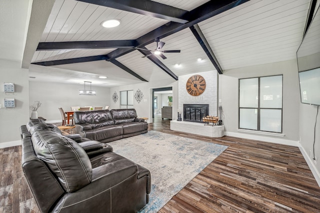 living room with wooden ceiling, lofted ceiling with beams, ceiling fan, a fireplace, and dark hardwood / wood-style flooring