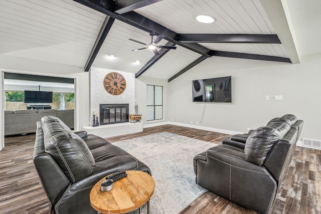 living room with a fireplace, lofted ceiling with beams, dark hardwood / wood-style floors, and ceiling fan