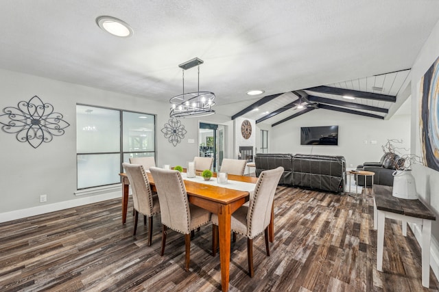 dining space featuring a textured ceiling, vaulted ceiling with beams, dark hardwood / wood-style flooring, and ceiling fan with notable chandelier