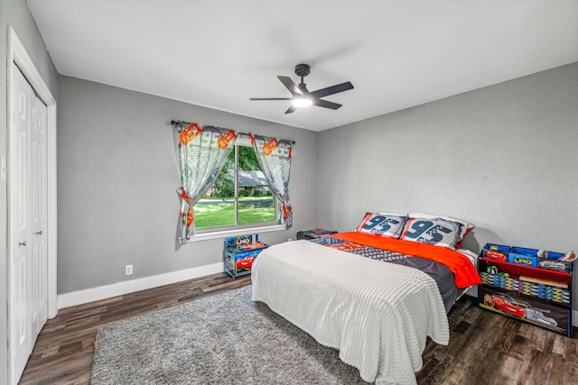 bedroom with dark hardwood / wood-style flooring, a closet, and ceiling fan