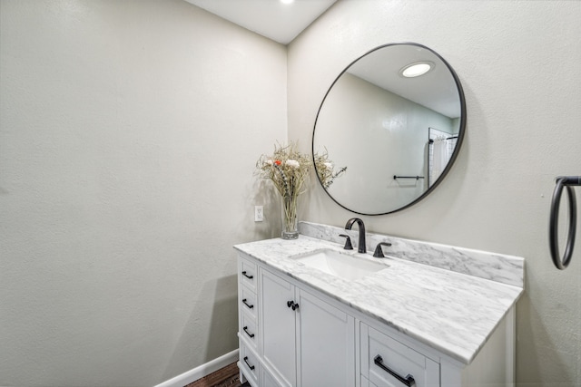 bathroom with hardwood / wood-style floors and vanity