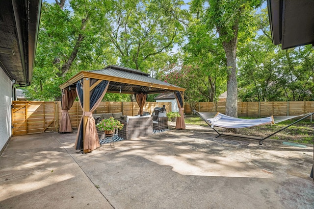 view of patio / terrace with a gazebo, a storage unit, and an outdoor living space