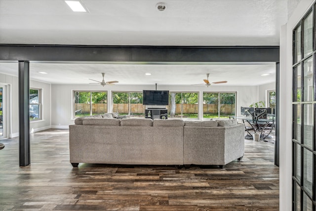 living room with a textured ceiling and dark wood-type flooring