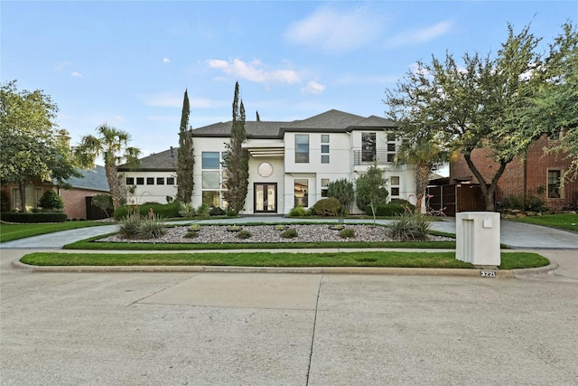 view of front of home with a balcony and french doors