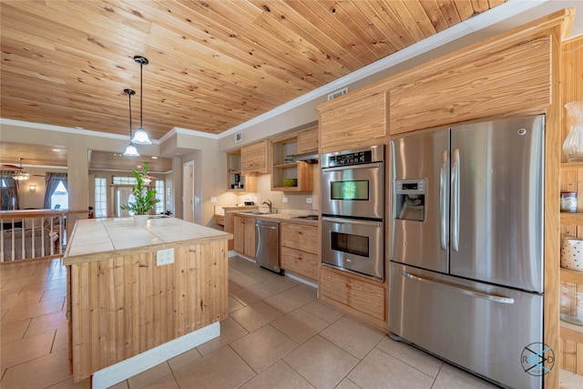 kitchen with hanging light fixtures, a center island, tile counters, appliances with stainless steel finishes, and wood ceiling