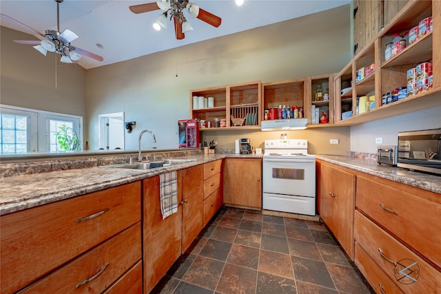 kitchen with dark tile patterned floors, ceiling fan, electric stove, light stone countertops, and sink