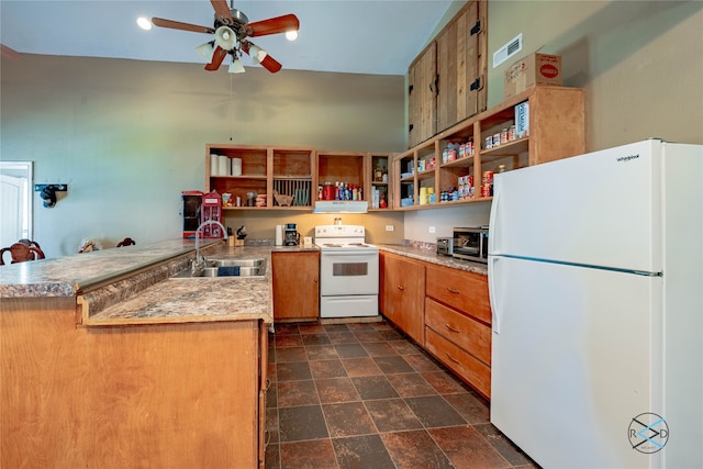 kitchen featuring ceiling fan, dark tile patterned floors, white appliances, sink, and kitchen peninsula