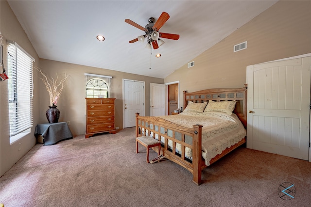 carpeted bedroom with multiple windows, ceiling fan, and lofted ceiling