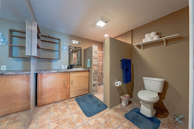 bathroom featuring tile patterned flooring, walk in shower, toilet, and vanity