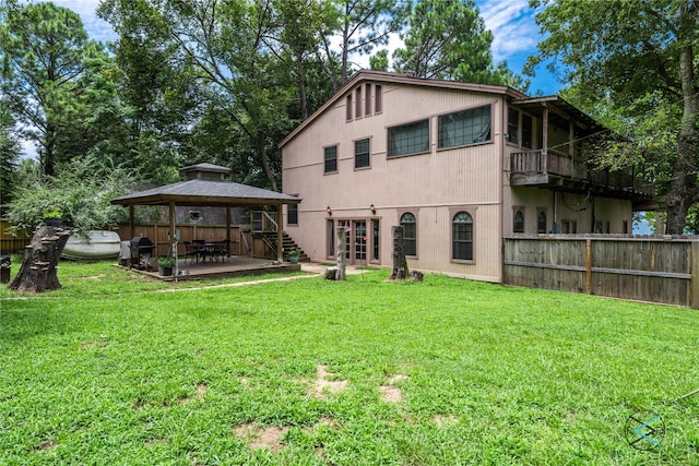 rear view of house featuring a yard, a gazebo, and a patio area