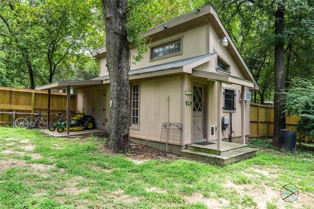 back of property with a lawn