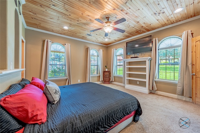 bedroom with wood ceiling, carpet floors, ceiling fan, and ornamental molding