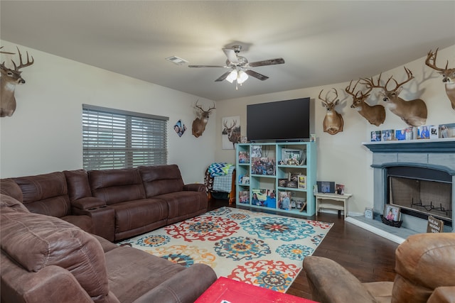 living room featuring ceiling fan and dark hardwood / wood-style flooring