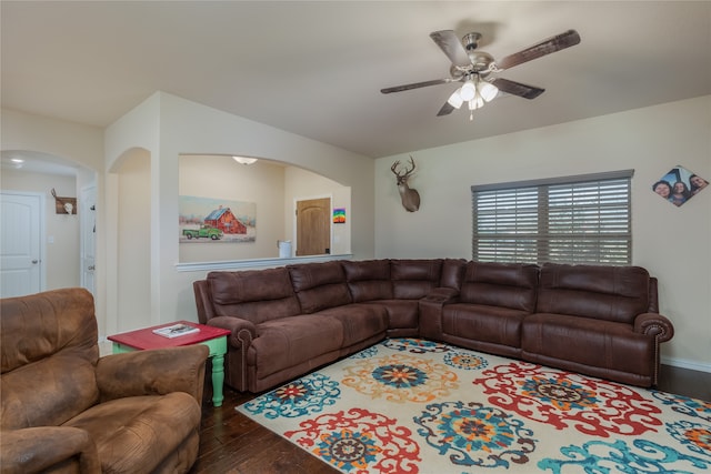 living room with dark hardwood / wood-style floors and ceiling fan