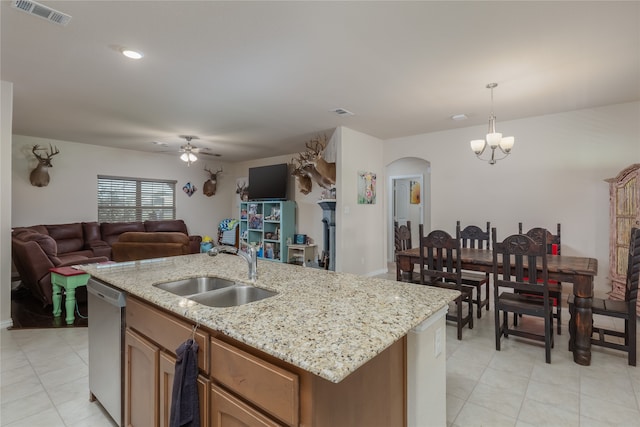 kitchen featuring a kitchen island with sink, sink, hanging light fixtures, and dishwasher