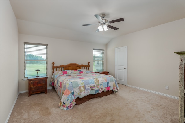 bedroom with ceiling fan, light colored carpet, and lofted ceiling