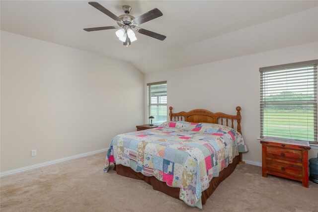 carpeted bedroom with ceiling fan and lofted ceiling