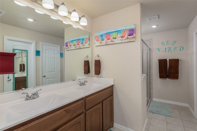 bathroom with tile patterned flooring, vanity, and a shower with shower door