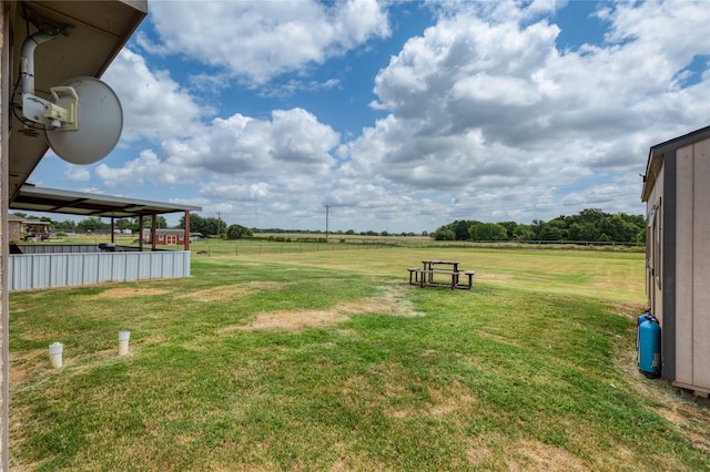 view of yard with a rural view