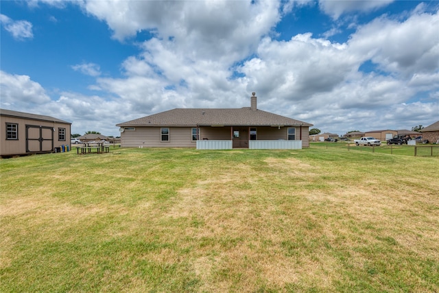 rear view of property with a lawn