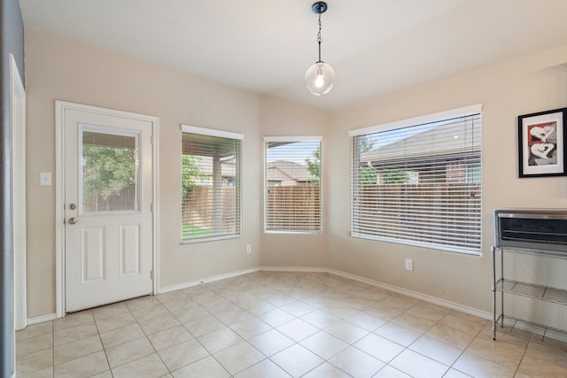 unfurnished dining area featuring light tile patterned flooring and a healthy amount of sunlight