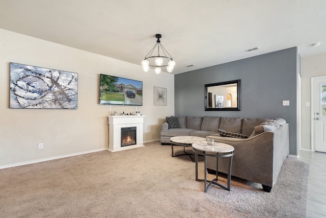 carpeted living room featuring a chandelier